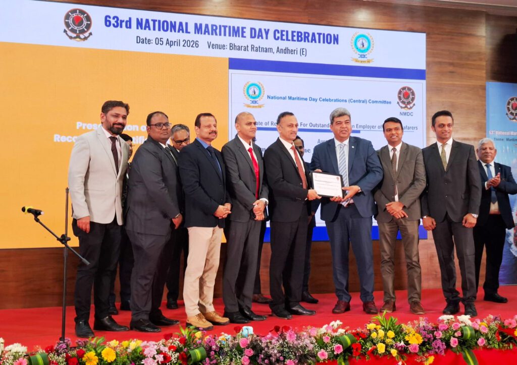 Maneesh Pradhan, Managing Director &ndash; Global Marine HR at Synergy Marine Group, accepting the "Outstanding Foreign Employer of Indian Seafarers" award at the 63rd National Maritime Day Celebration in Mumbai, April 2026. A group of maritime leaders stands on stage against a backdrop highlighting the event theme.