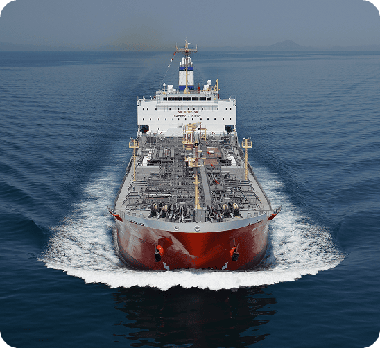 Large commercial cargo ship and oil tanker navigating open ocean waters, demonstrating fleet operations.